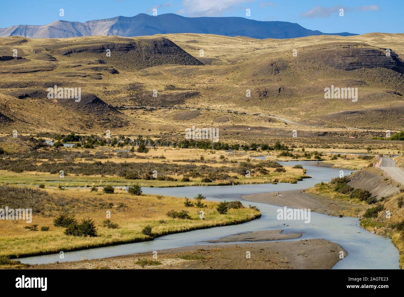 A river with pure water finds a way through the arid landscape near Torres del Paine in Chile. Stock Photo