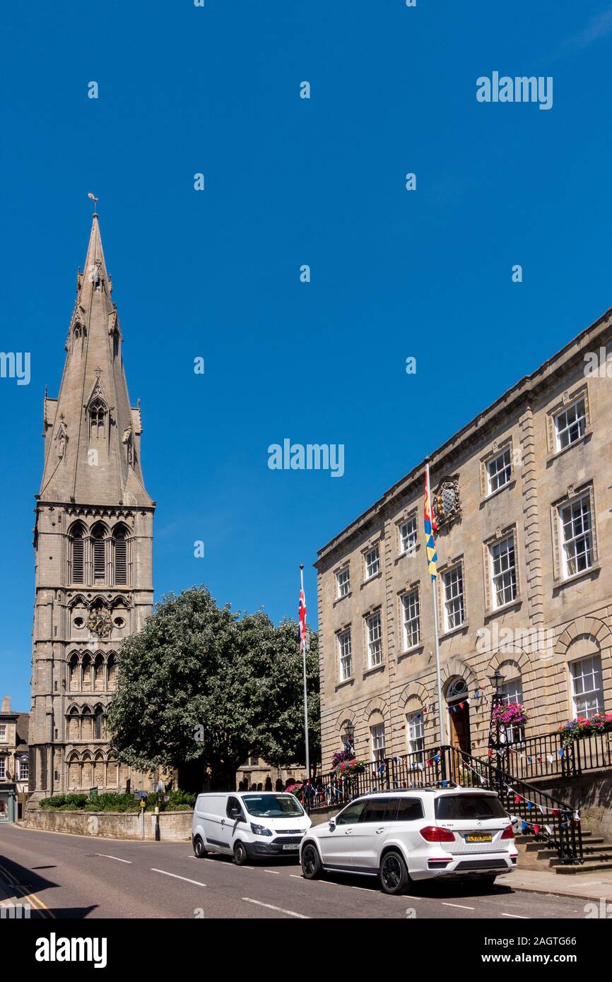 St Mary's Church Tower and Stamford Town Hall building on a Summer day with clear blue sky, Stamford, Lincolnshire, England, UK Stock Photo