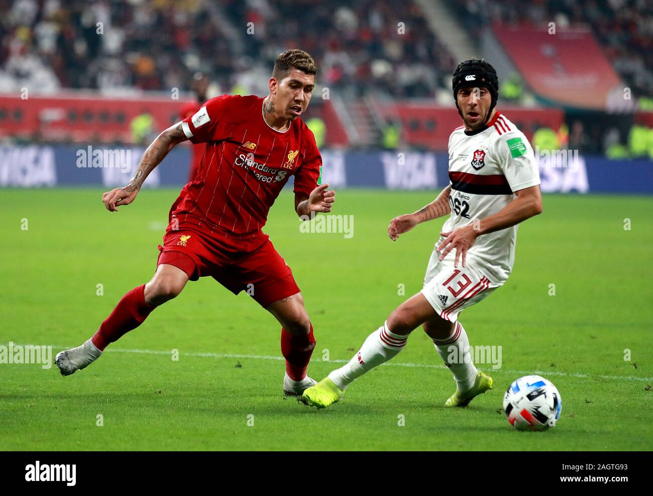 Liverpool's Roberto Firmino (left) and Flamengo's Rafinha (right) battle for the ball during the FIFA Club World Cup final at the Khalifa International Stadium, Doha. Stock Photo