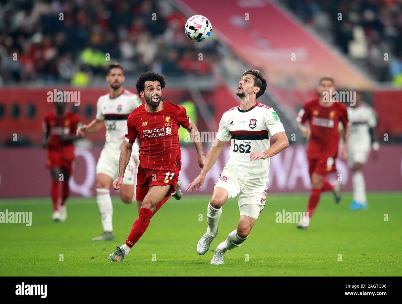 Liverpool's Mohamed Salah (left) and Flamengo's Rodrigo Caio (right) battle for the ball during the FIFA Club World Cup final at the Khalifa International Stadium, Doha. Stock Photo