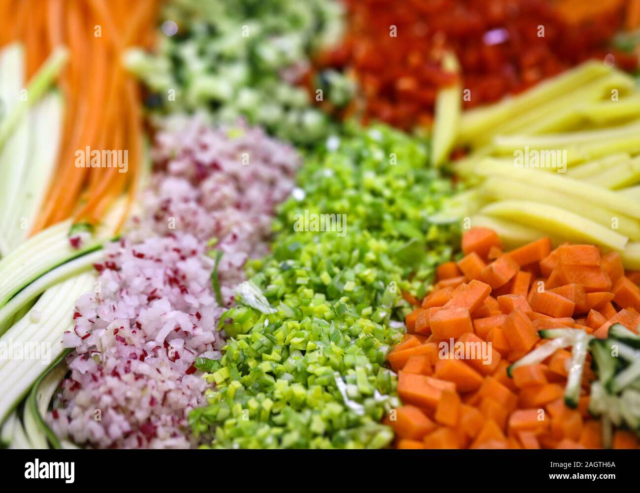 Different raw shredded vegetables and fruits as an example of a healthy