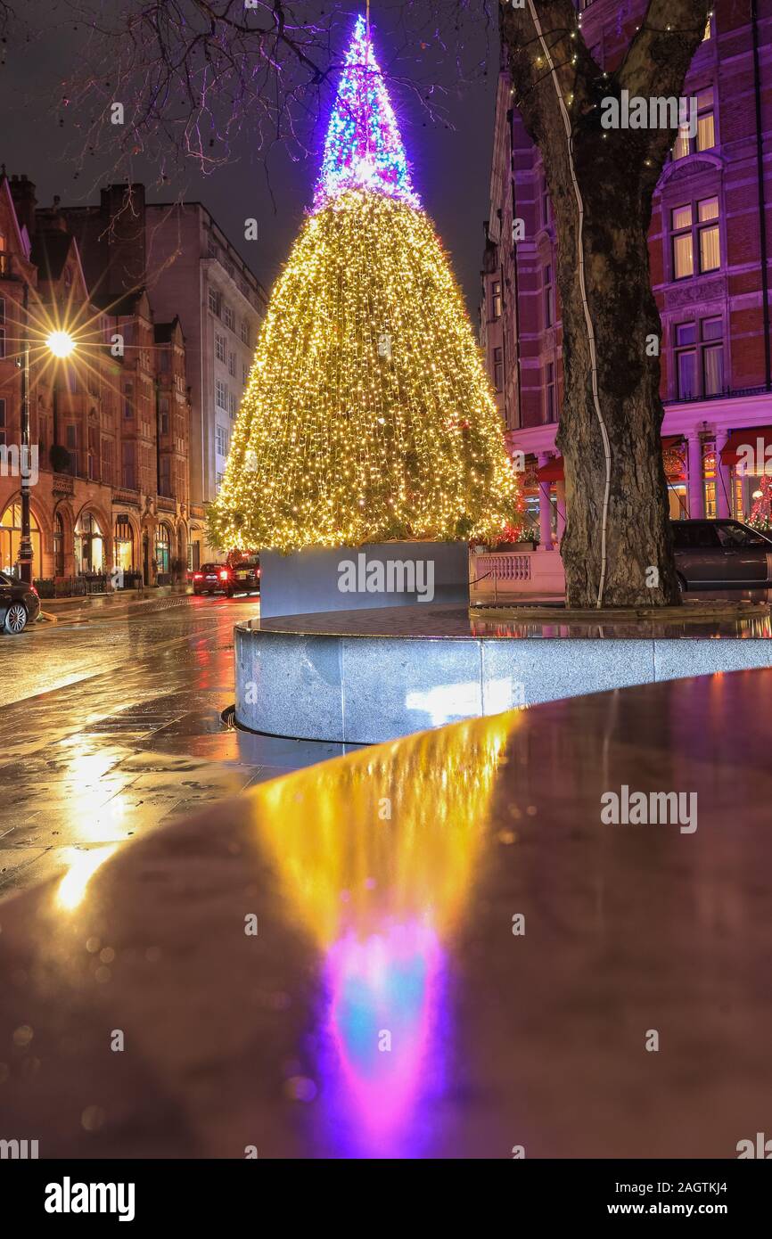 Central London, London, 21st Dec 2019. The beautifully illuminated Christmas Tree outside the Connaught Hotel in Mayfair. Shops, hotels, restaurants and residences have all decked the halls and decorated their entrances in festive splendor around Mayfair, Oxford Street and Regent Street in London in the last few days before Christmas. Stock Photo