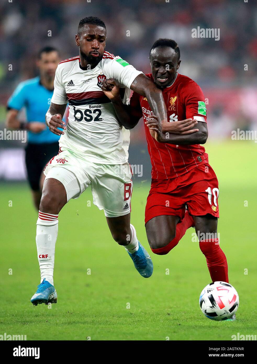 Flamengo's Gerson (left) and Liverpool's Sadio Mane (right) battle for the ball during the FIFA Club World Cup final at the Khalifa International Stadium, Doha. Stock Photo