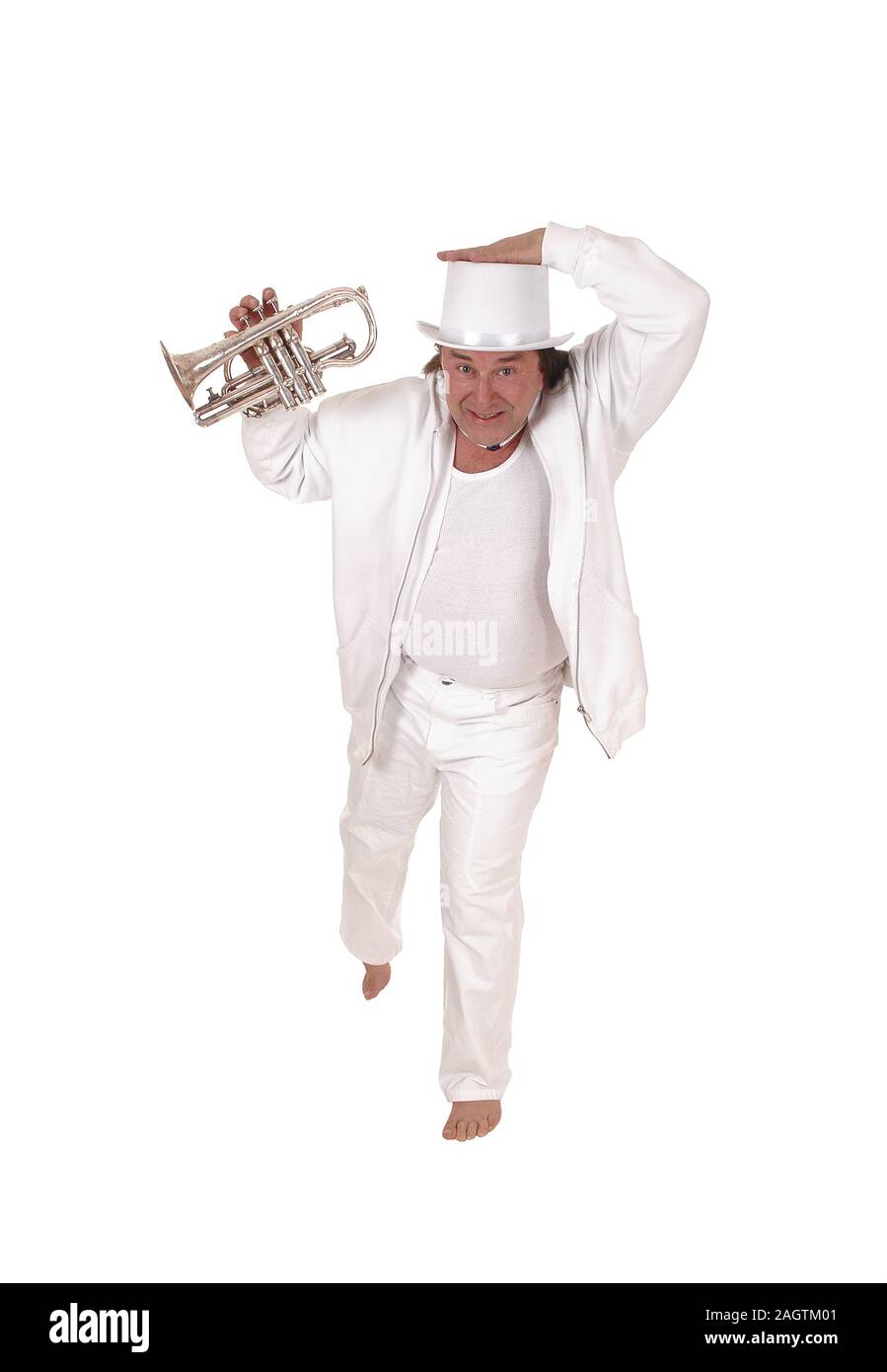 A middle age indigenous man dancing in a white outfit and white hat playing his trumpet with his long hair, isolated for white background Stock Photo
