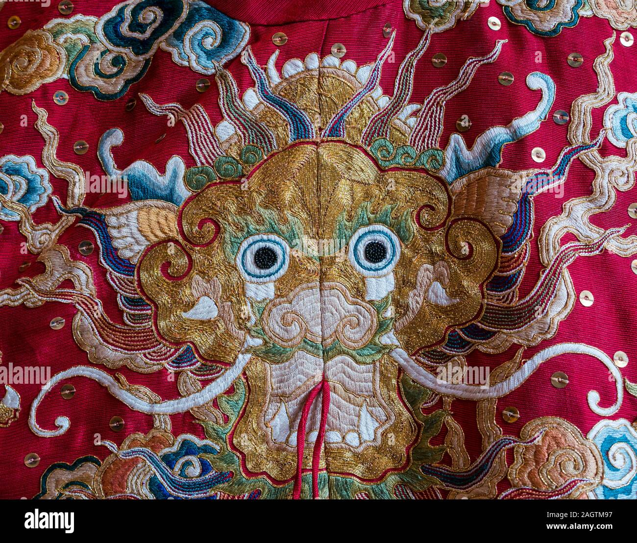 Close up detail of hand embroidery on recreated Vietnamese silk Imperial robe with dragon of
