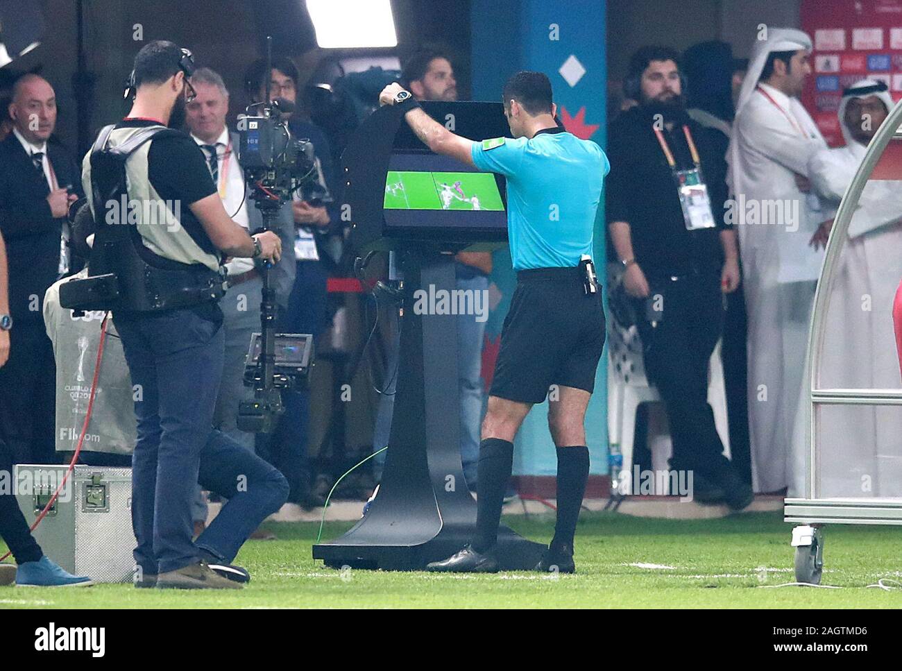 Match referee Abdulrahman Al Jassim consults VAR after an incident involving Liverpool's Sadio Mane and Flamengo's Rafinha during the FIFA Club World Cup final at the Khalifa International Stadium, Doha. Stock Photo