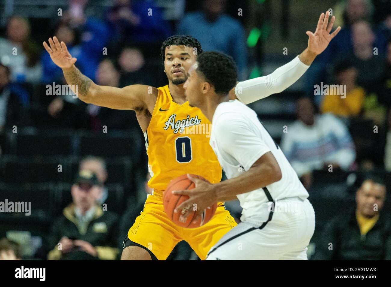 Winston-Salem, NC, USA. 21st Dec, 2019. North Carolina A&T Aggies guard Andre Jackson (0) defends Wake Forest Demon Deacons guard Brandon Childress (0) during the second half of the NCAA Basketball matchup at LJVM Coliseum in Winston-Salem, NC. (Scott Kinser/Cal Sport Media). Credit: csm/Alamy Live News Stock Photo