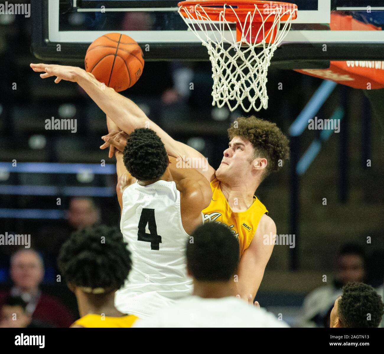 Winston-Salem, NC, USA. 21st Dec, 2019. Wake Forest Demon Deacons guard Jahcobi Neath (4) gets fouled by North Carolina A&T Aggies center Harry Morrice (14) as he goes up for a shot during the second half of the NCAA Basketball matchup at LJVM Coliseum in Winston-Salem, NC. (Scott Kinser/Cal Sport Media). Credit: csm/Alamy Live News Stock Photo