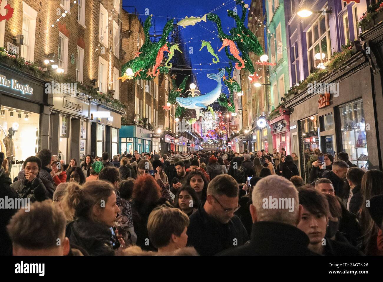 Central London, London, 21st Dec 2019. Carnaby Street is crowded with shoppers. Shoppers in Oxford Street, Regent Street and Bond Street rush to make their last minute purchases in time for Christmas, whilst shops have already started heavy discounting on many goods. Stock Photo