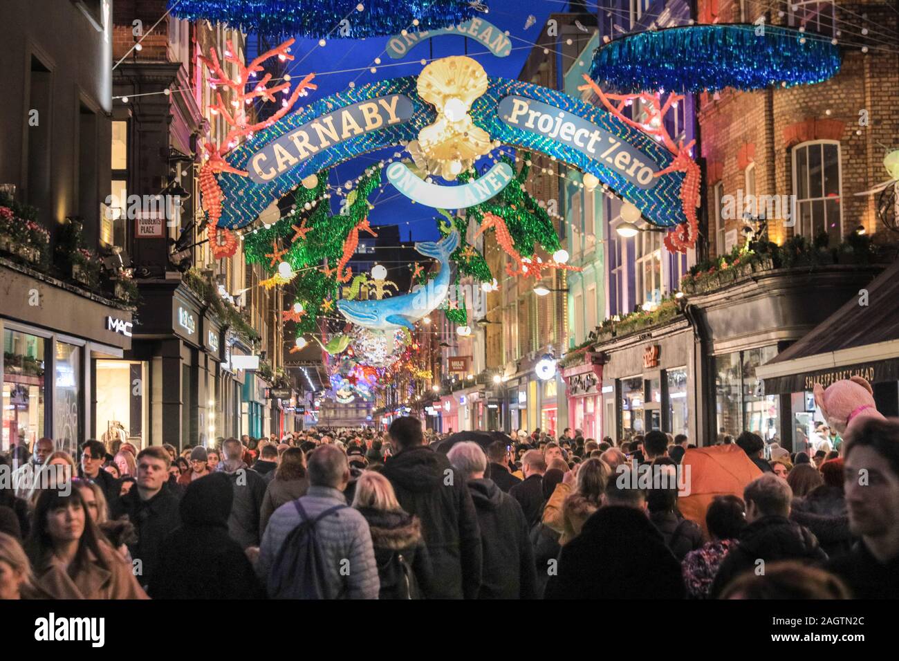 Central London, London, 21st Dec 2019. Carnaby Street is crowded with shoppers. Shoppers in Oxford Street, Regent Street and Bond Street rush to make their last minute purchases in time for Christmas, whilst shops have already started heavy discounting on many goods. Stock Photo