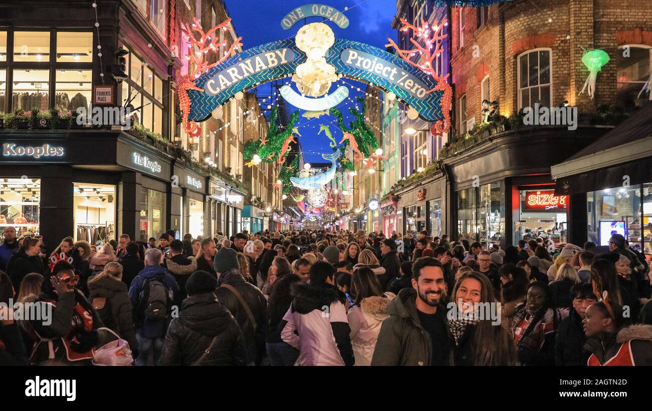 Central London, London, 21st Dec 2019. Carnaby Street is crowded with shoppers. Shoppers in Oxford Street, Regent Street and Bond Street rush to make their last minute purchases in time for Christmas, whilst shops have already started heavy discounting on many goods. Stock Photo