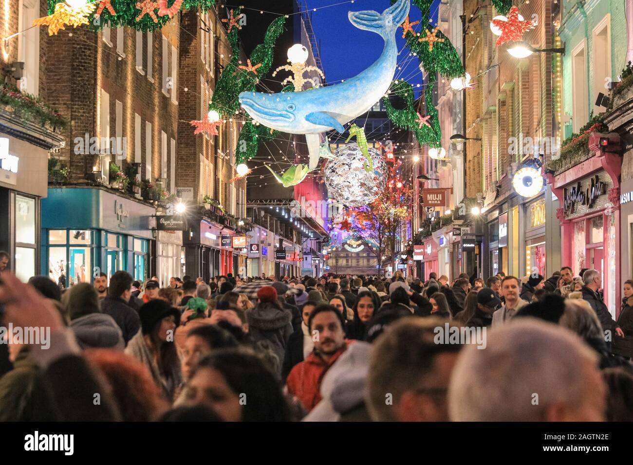 Central London, London, 21st Dec 2019. Carnaby Street is crowded with shoppers. Shoppers in Oxford Street, Regent Street and Bond Street rush to make their last minute purchases in time for Christmas, whilst shops have already started heavy discounting on many goods. Stock Photo