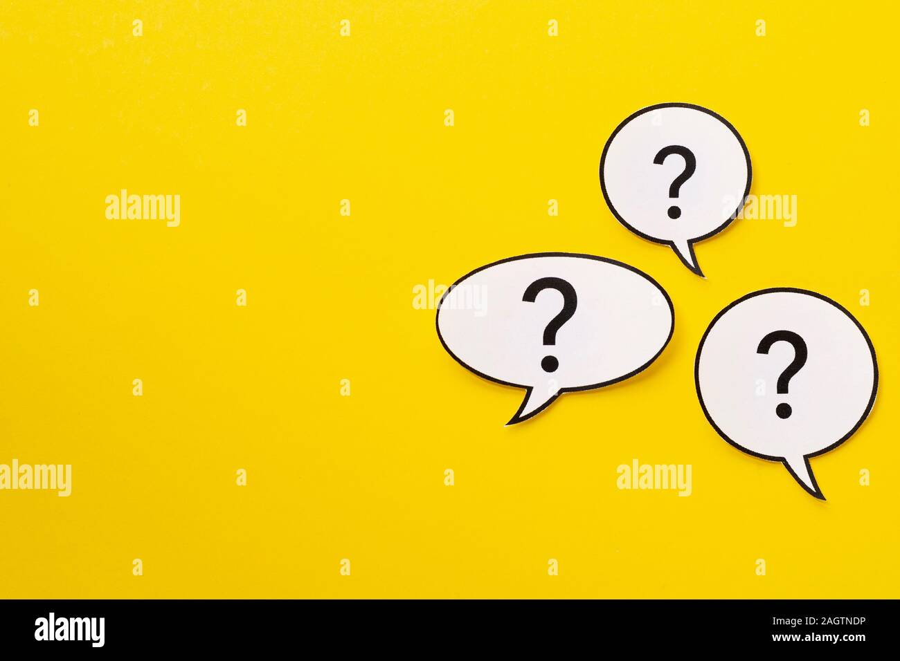 Three different shaped speech bubbles over a bright yellow background Stock Photo