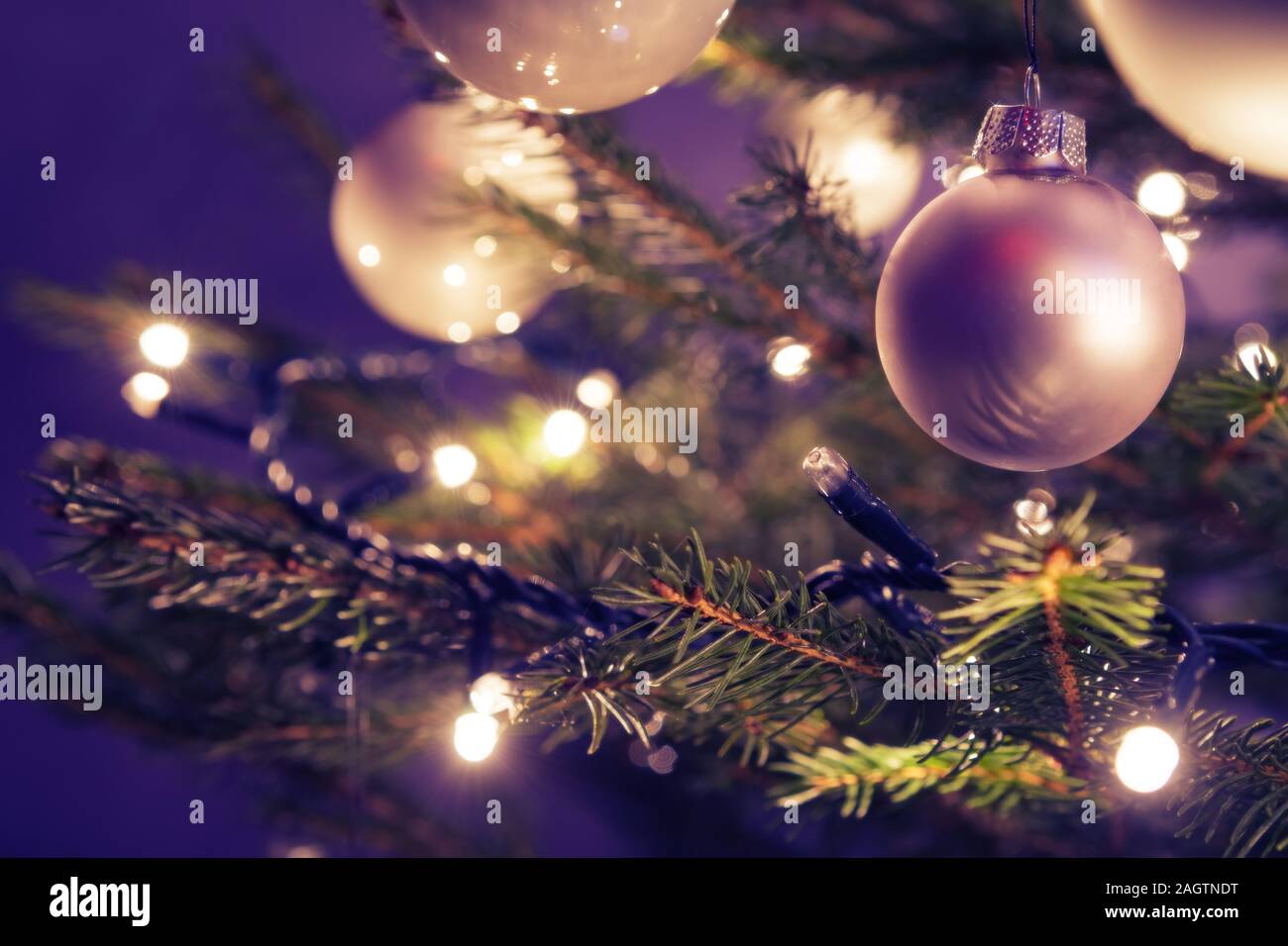 Closeup of Christmas ornaments and lights on real Christmas tree and