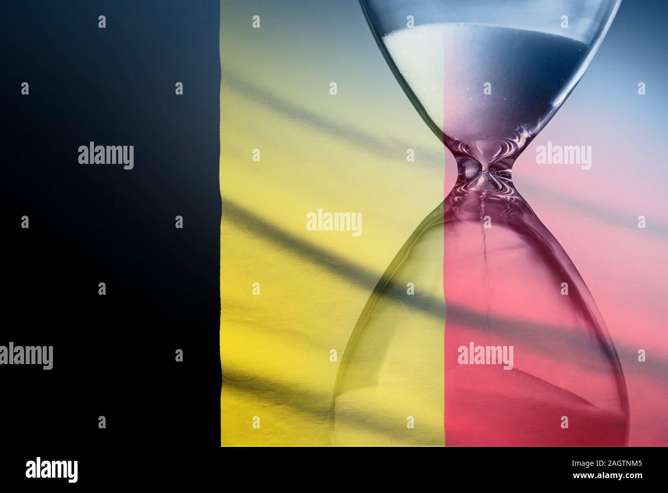 Flag of Belgium with superimposed hourglass conceptual of deadlines Stock Photo