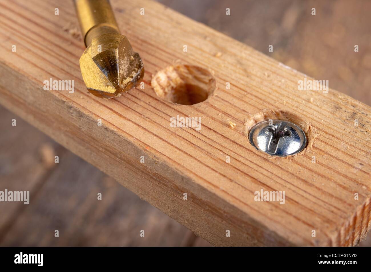 Drilling holes in a piece of wood. Countersinking the hole for wood