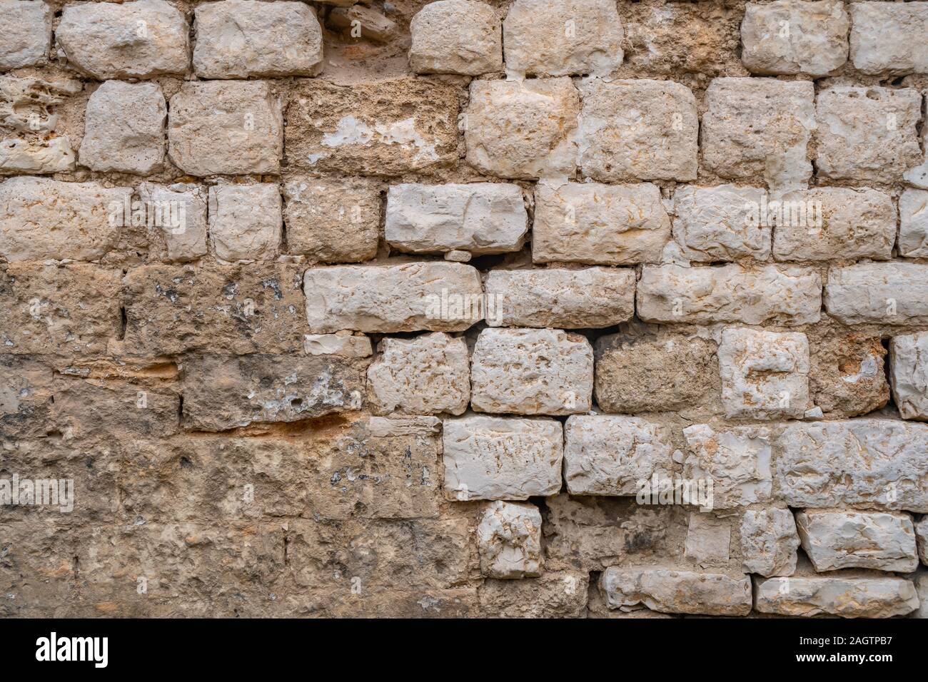 Gray old stone wall background. yellow rock wall made of stone. Texture ...
