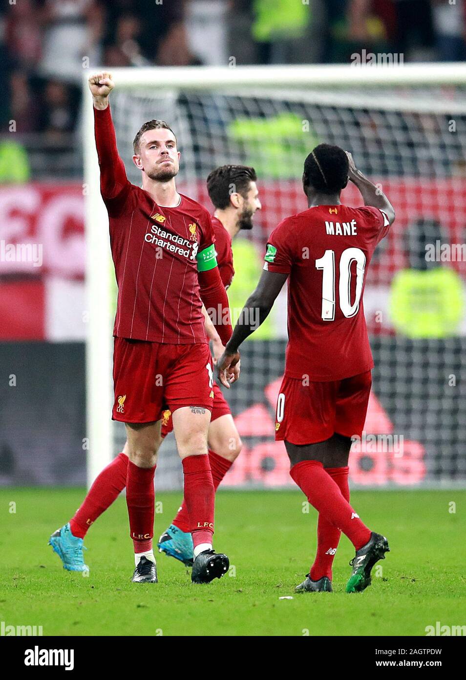 Liverpool's Jordan Henderson (left) celebrates victory after the FIFA Club World Cup final at the Khalifa International Stadium, Doha. Stock Photo