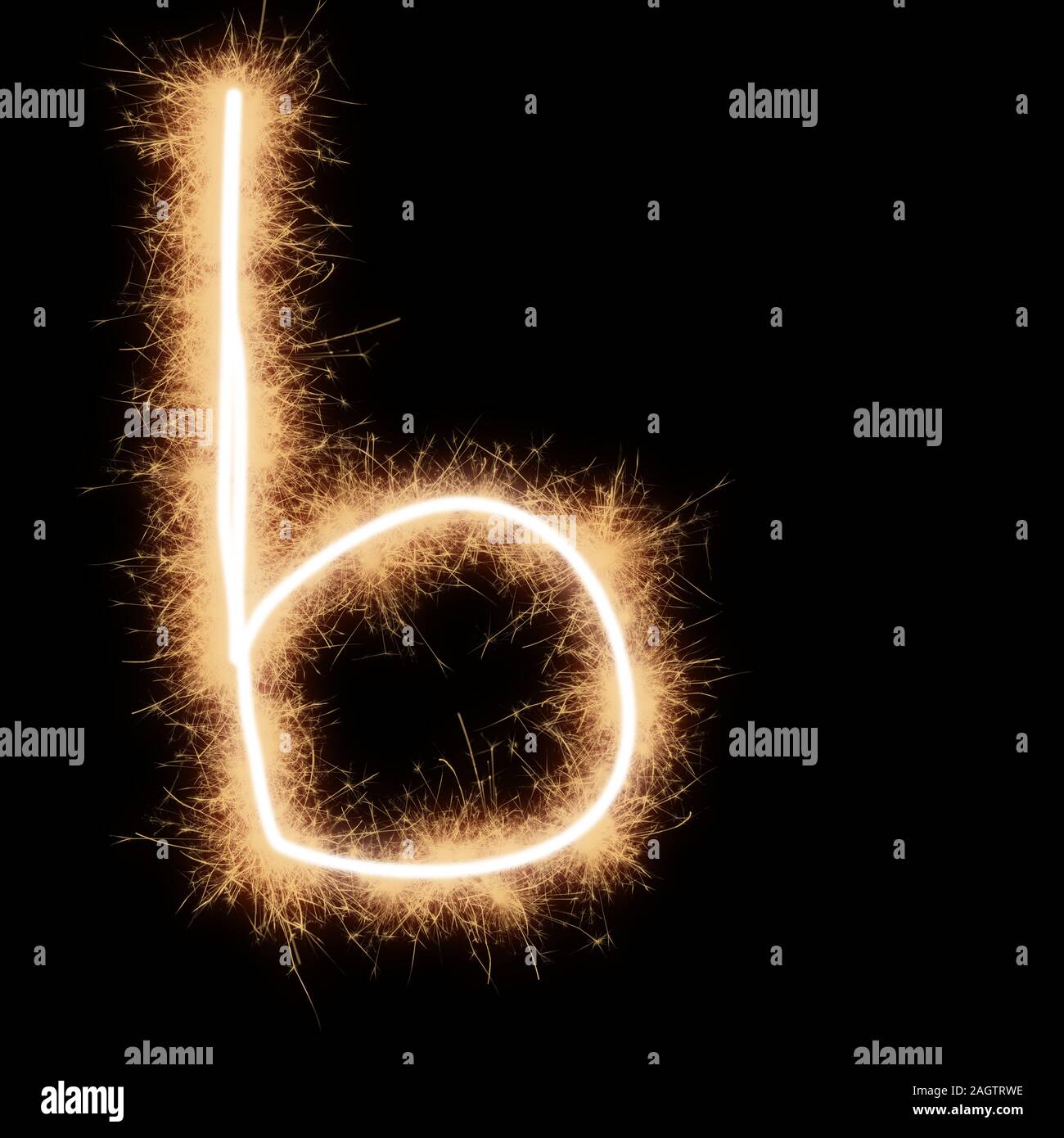 Lower case b letter of alphabet written by squib sparks on a black background. Stock Photo