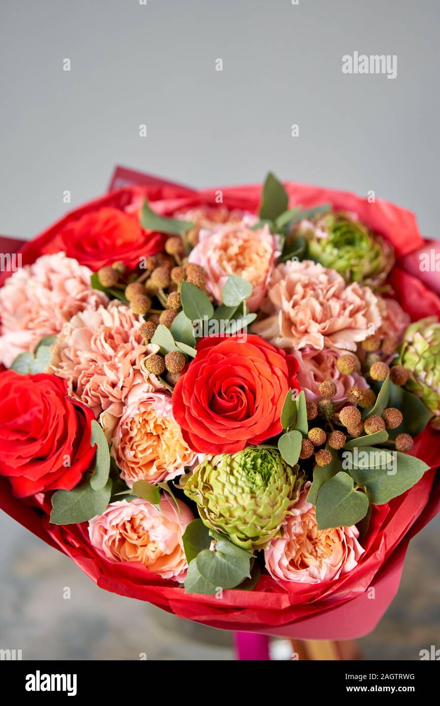 European floral shop. Beautiful bouquet of mixed flowers in glas vase. the  work of the florist at a flower shop. Delivery fresh cut flower Stock Photo  - Alamy