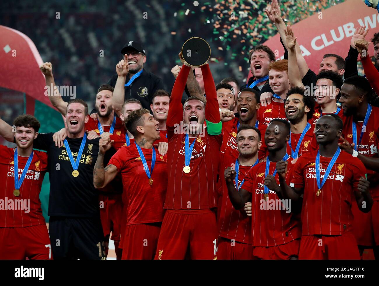 Liverpool's Jordan Henderson celebrates with the trophy after the FIFA Club World Cup final at the Khalifa International Stadium, Doha. Stock Photo