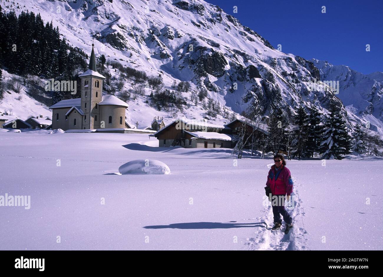 Walker woman front of Champagny en Vanoise small mountain village of Savoie Good place for Cross-country skiing Stock Photo