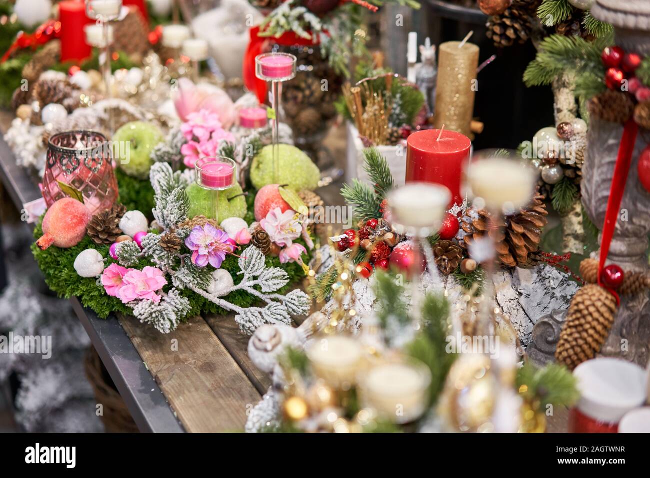 Assortment of European flower shop. Beautiful festive wreath of fresh spruce. Christmas mood. Xmas tree. Bokeh of Garland lights on background Stock Photo