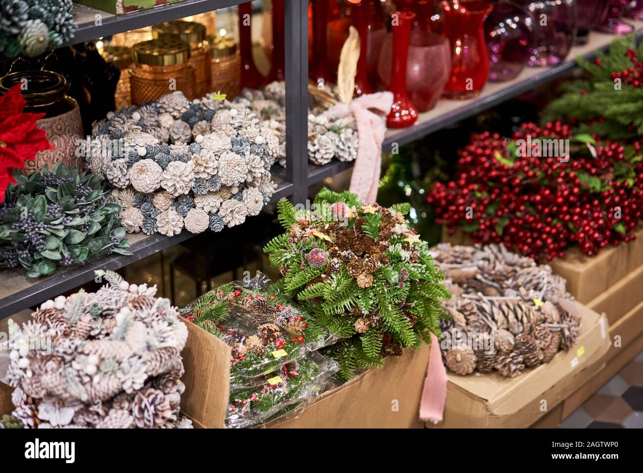 Assortment of European flower shop. Beautiful festive wreath of fresh spruce. Christmas mood. Xmas tree. Bokeh of Garland lights on background Stock Photo