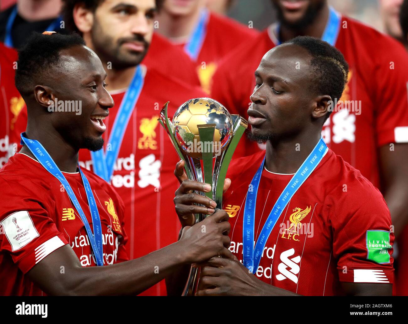 Liverpool's Sadio Mane (right) and Naby Keita (left) celebrate with the trophy after the FIFA Club World Cup final at the Khalifa International Stadium, Doha. Stock Photo