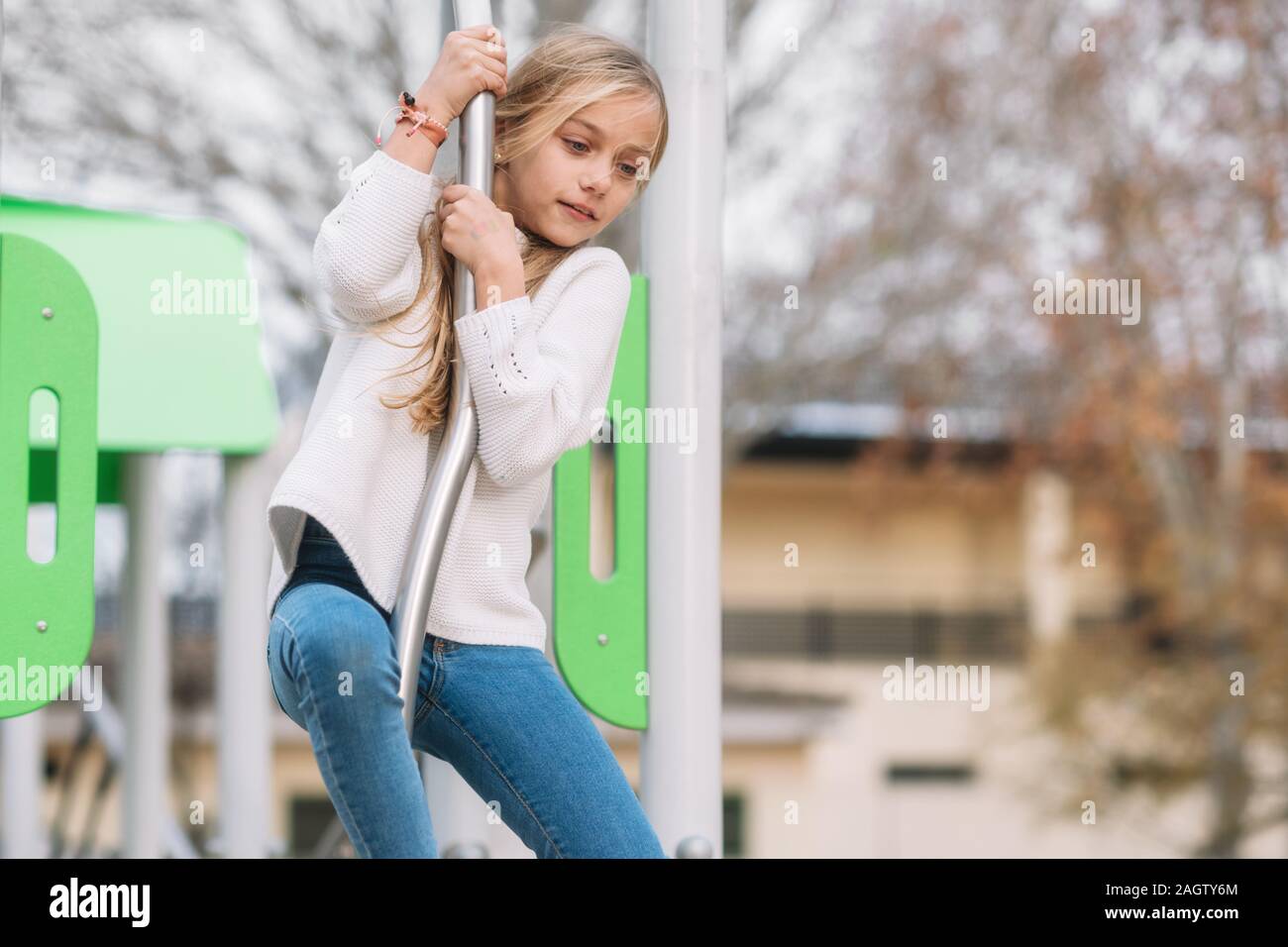 blonde girl climbs on his pole and slides