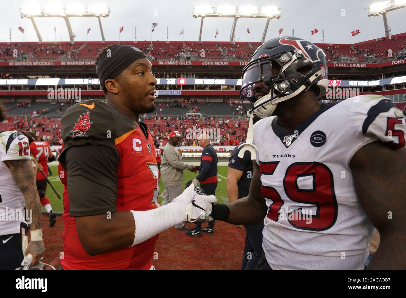 Tampa, Florida, USA. 21st Dec, 2019. Tampa Bay Buccaneers quarterback Jameis Winston (3) and Houston Texans linebacker Whitney Mercilus (59) on the field after the NFL game between the Houston Texans and the Tampa Bay Buccaneers held at Raymond James Stadium in Tampa, Florida. Andrew J. Kramer/Cal Sport Media/Alamy Live News Stock Photo