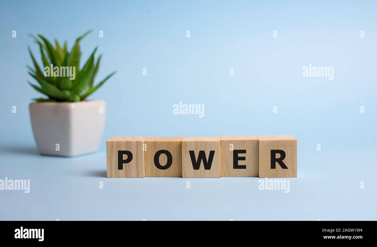 Wooden word power word on blue background Stock Photo