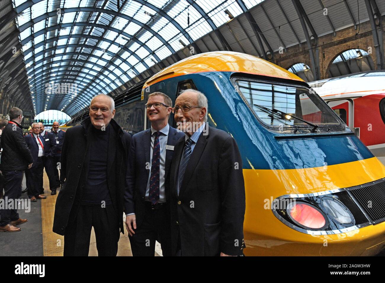 King's Cross Station, London, UK. 21st December 2019. London North Eastern Railway Company restored an InterCity 125 set to its original British Rail livery for a special four-day tour around the LNER network as the trains end 40 years of service on the East Coast Main Line. Sir Kenneth Grange the loco designer poses with LNER MD David Horne and David Russell, BR engineer who introduced HST's to the East Coast Main Line . G.P. Essex/Alamy Live News Stock Photo
