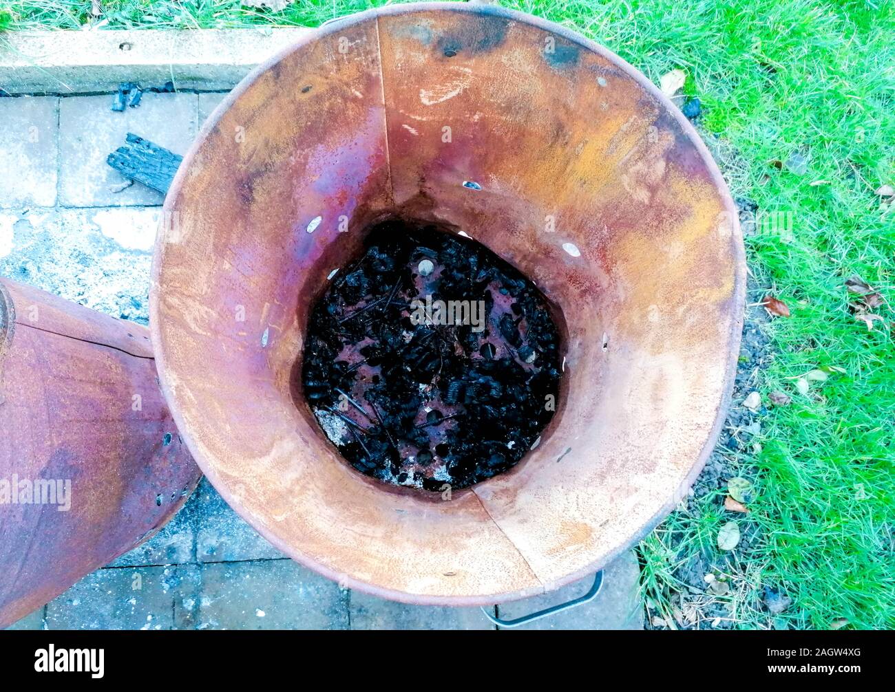 A burn bin that has been used to burn wood, paper and other combustible
