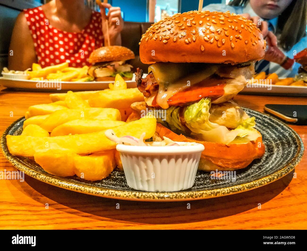 A typical British pub lunch meal. Burger, chips and coleslaw Stock