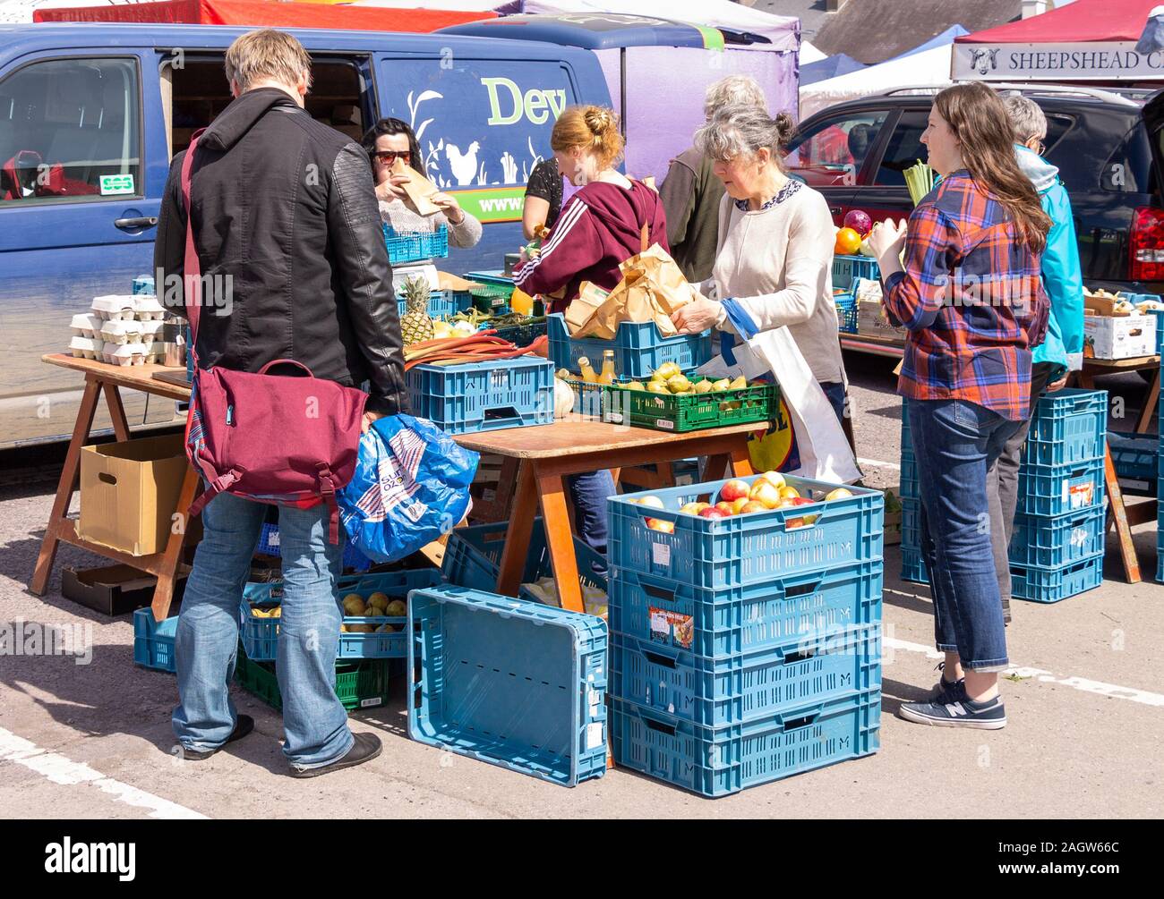 shoppers buying fruit and vegetables at a country market stall Stock Photo