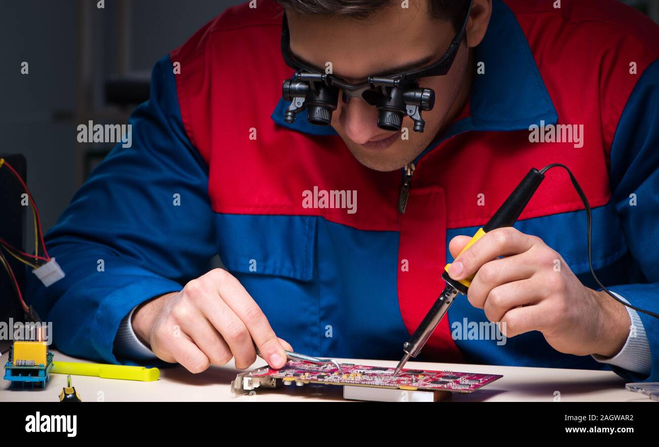 The computer specialist repairing pc late at night Stock Photo - Alamy