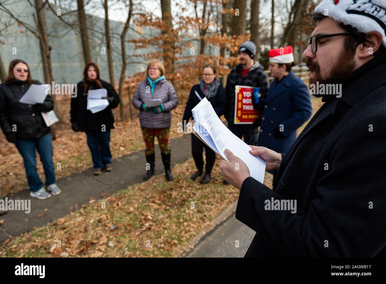 Exton, USA. 21st Dec, 2019. Exton Pennsylvania / USA. About twenty people gathered in suburban Exton Pennsylvania singing Christmas carols with altered lyrics to protest the arrest of two pipeline activists, Mark and Malinda Clatterbuck. Local residents used the Christmas-themed rally to push back on ongoing intimidation by pipeline company Sunoco. Credit: Chris Baker Evens / Alamy Live News. Credit: Christopher Evens/Alamy Live News Stock Photo