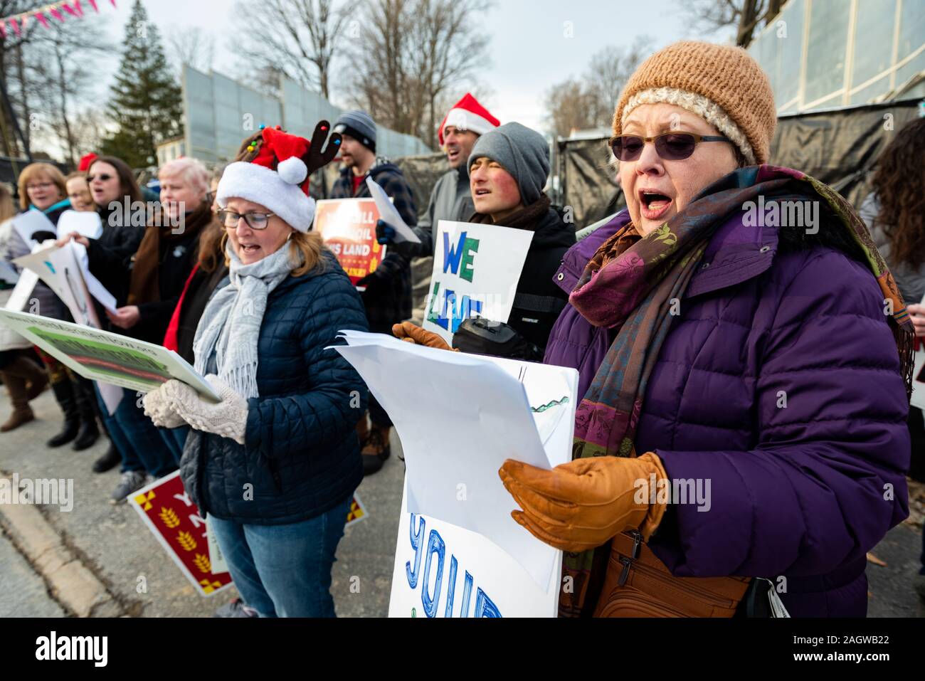 Exton, USA. 21st Dec, 2019. Exton Pennsylvania / USA. About twenty people gathered in suburban Exton Pennsylvania singing Christmas carols with altered lyrics to protest the arrest of two pipeline activists, Mark and Malinda Clatterbuck. Local residents used the Christmas-themed rally to push back on ongoing intimidation by pipeline company Sunoco. Credit: Chris Baker Evens / Alamy Live News. Credit: Christopher Evens/Alamy Live News Stock Photo