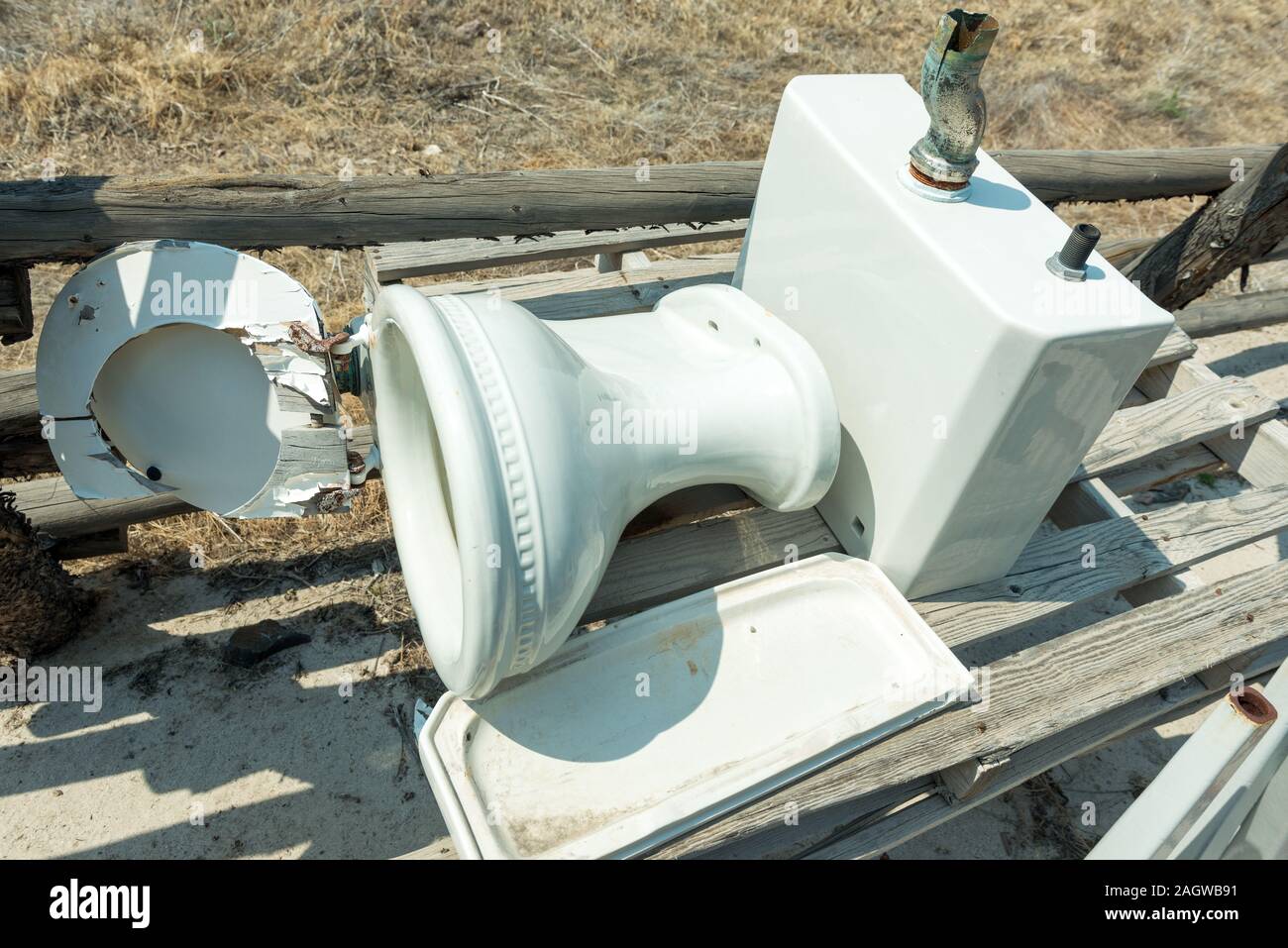 Broken Toilet on a Wood Pallet Stock Photo