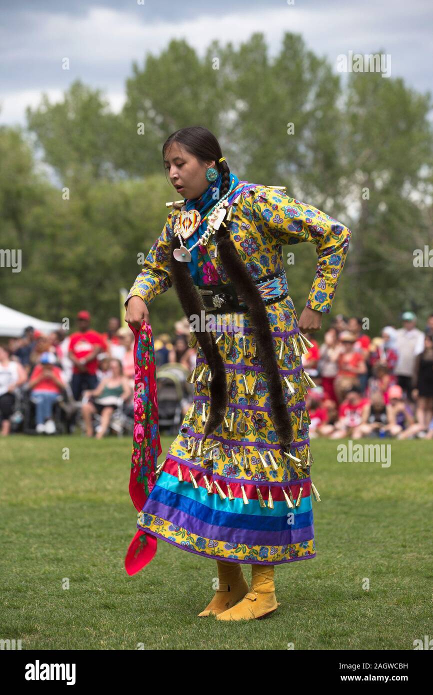 Indigenous woman performing jingle dance during Canada Day powwow Stock
