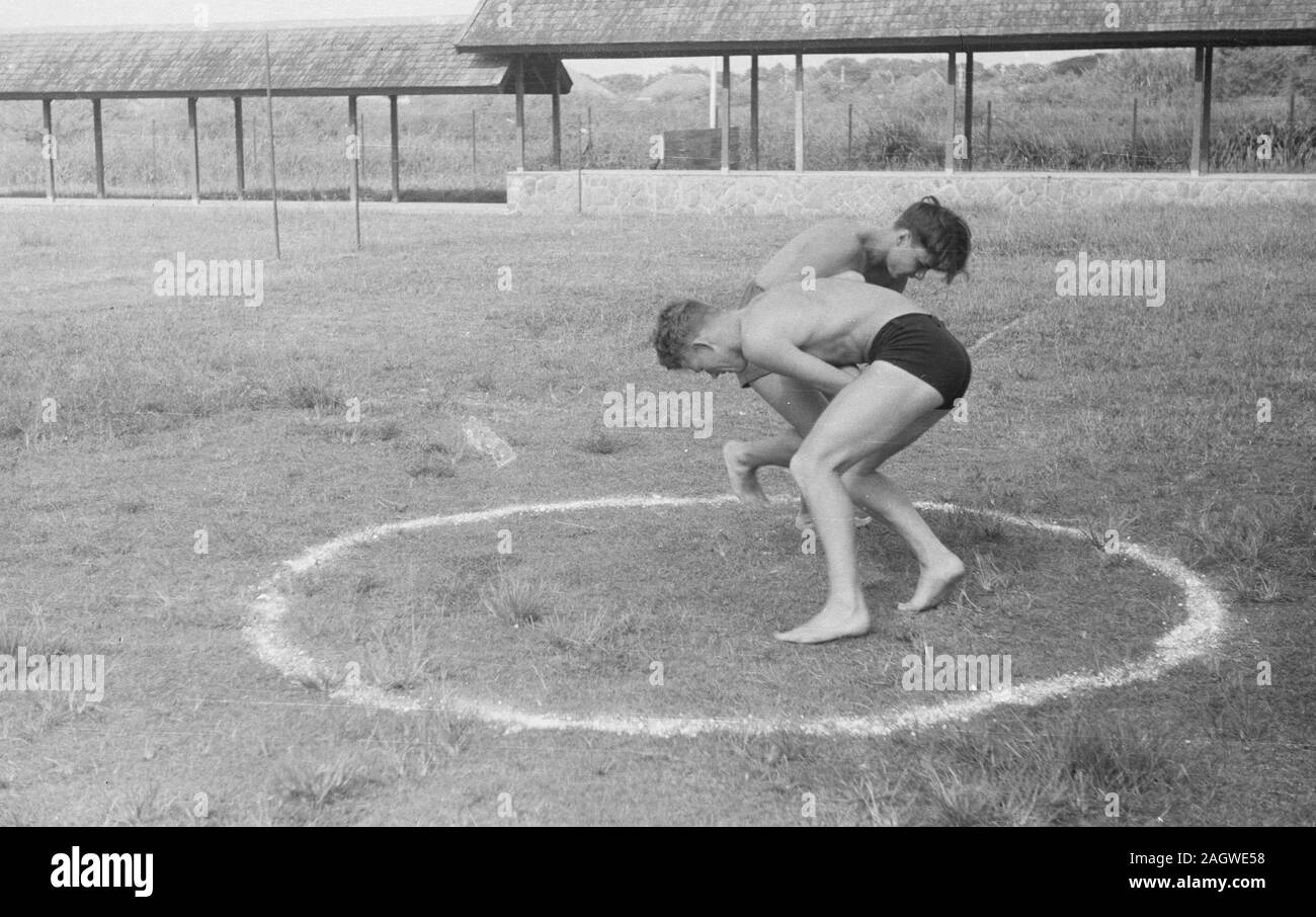 Young soldiers wrestling in Bandoeng, Indonesia, Java, Dutch East Indies ca. 1947 Stock Photo