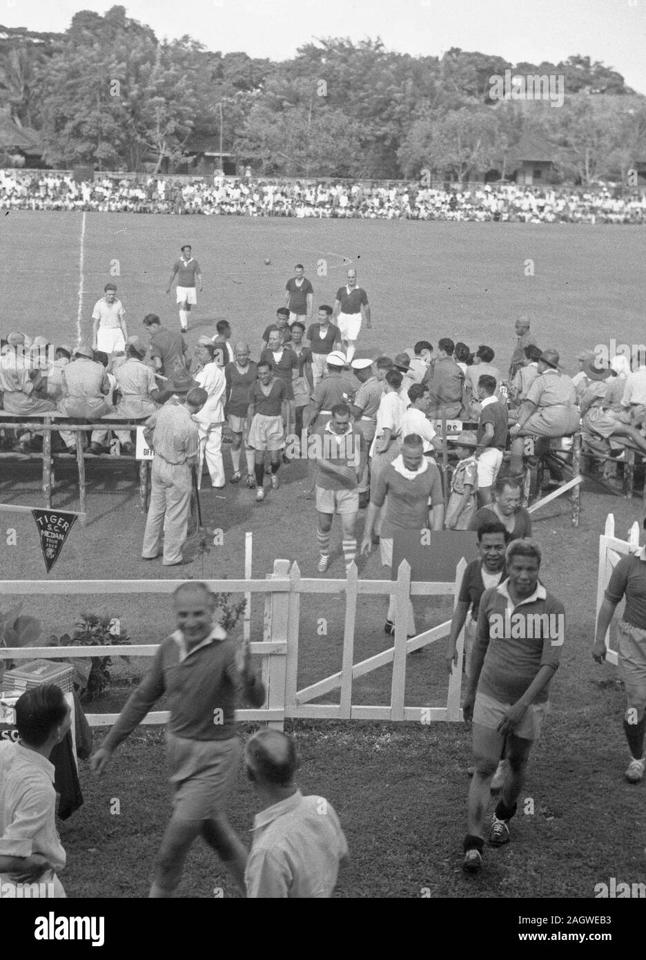 Players leave field after soccer game - August 31, 1948 Location Indonesia, Medan, Dutch East Indies, Sumatra Stock Photo