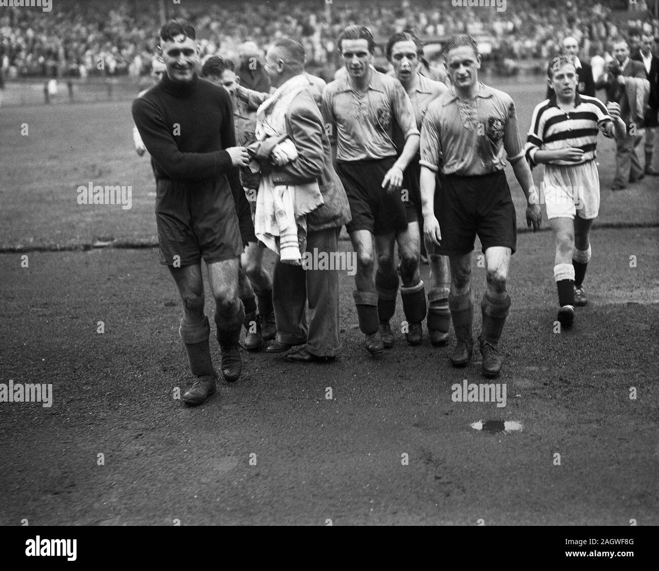 September 21, 1947 - Soccer players leaving the field after a match Stock Photo