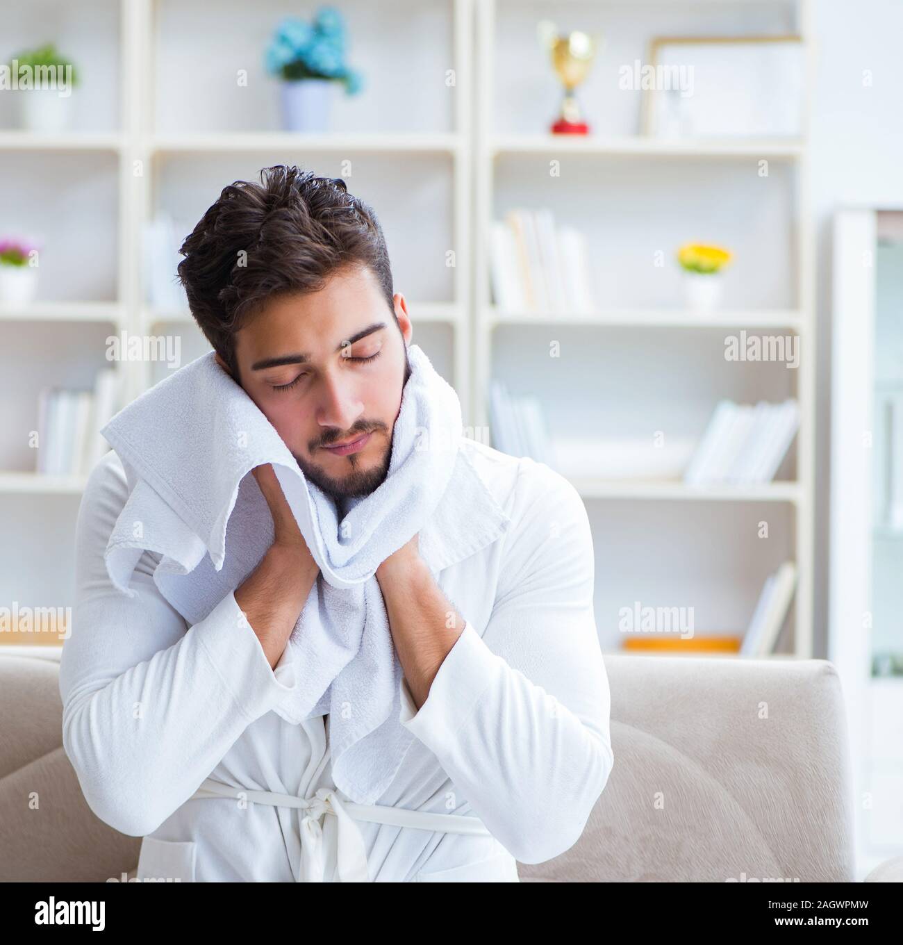 The young man in a bathrobe after shower drying hair with a towel Stock Photo - Alamy The young man in a bathrobe after shower drying hair with a towel Stock Photo - Alamy