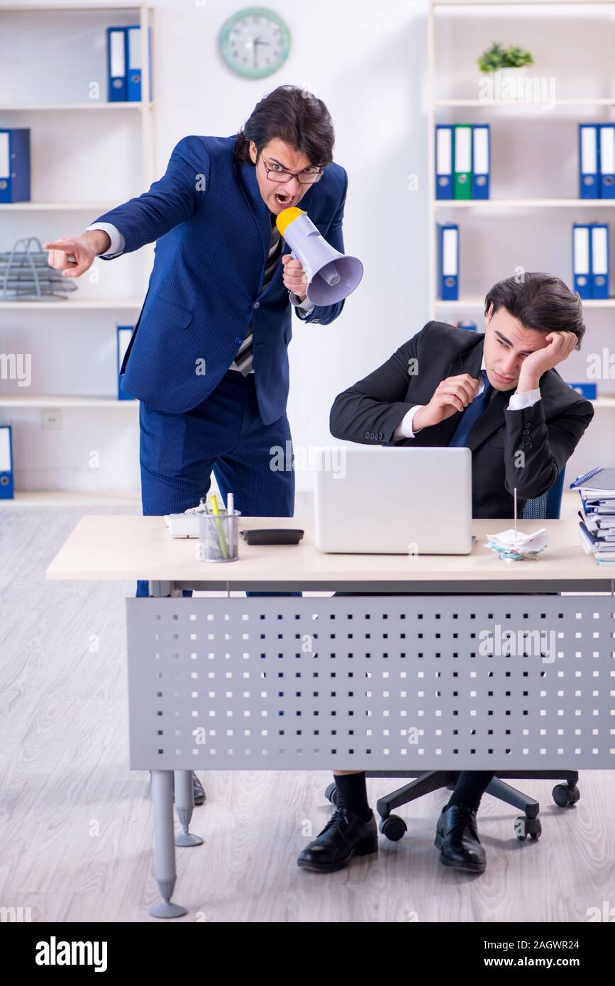 The boss and his male assistant working in the office Stock Photo - Alamy