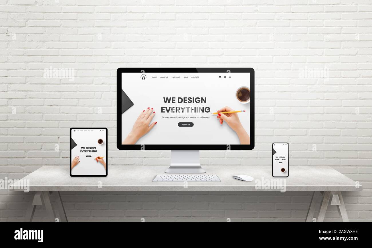 Designer desk with computer display, tablet and phone. Designer studio page on device displays. Resonsive web design concept Stock Photo
