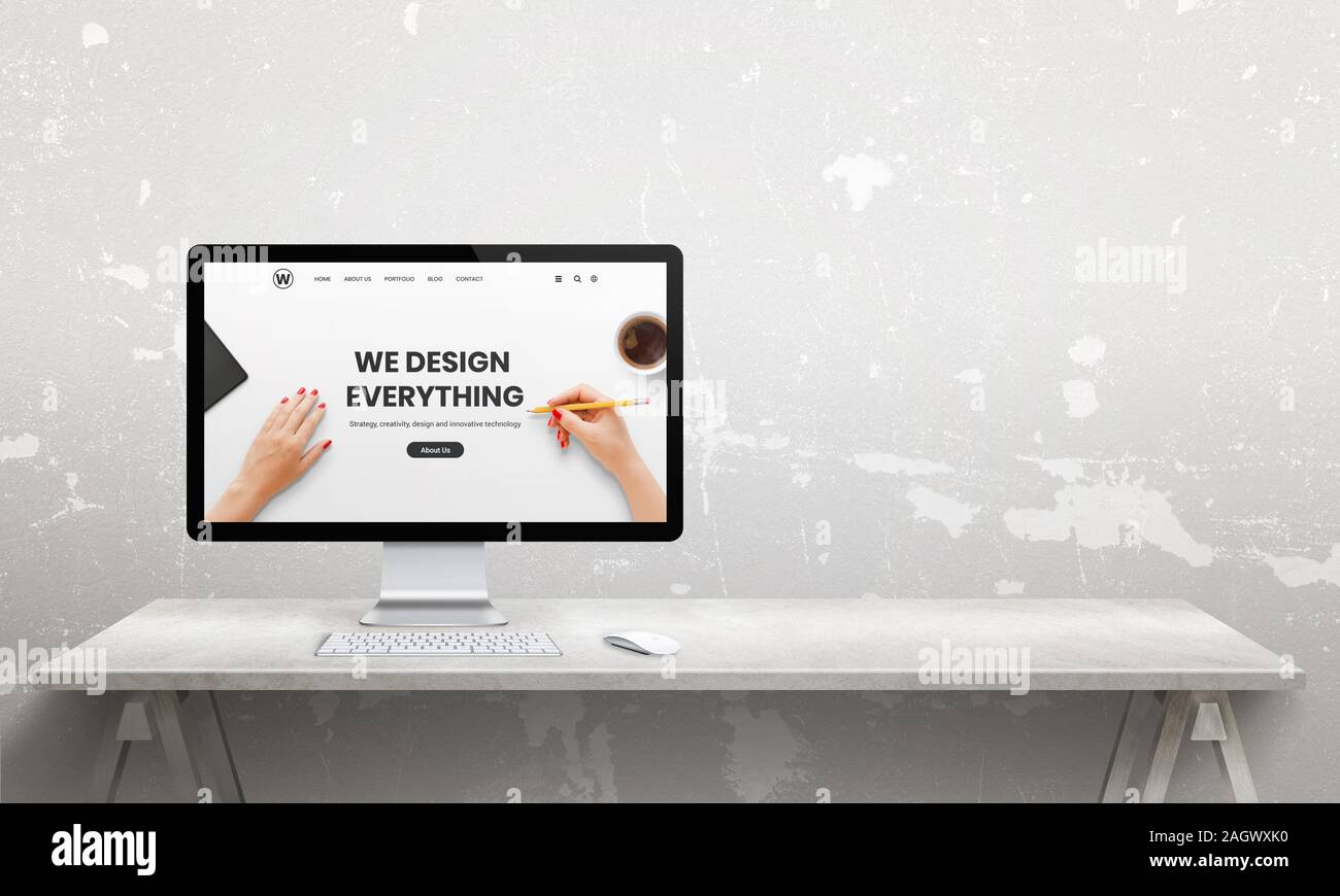 Web design studio with computer  display and modern agency web page. Copy space beside. Modern, flat  studio desk Stock Photo