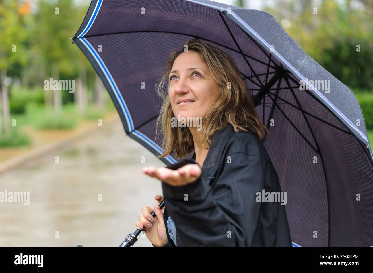 in the city on the street a girl with an umbrella in the rain Stock ...