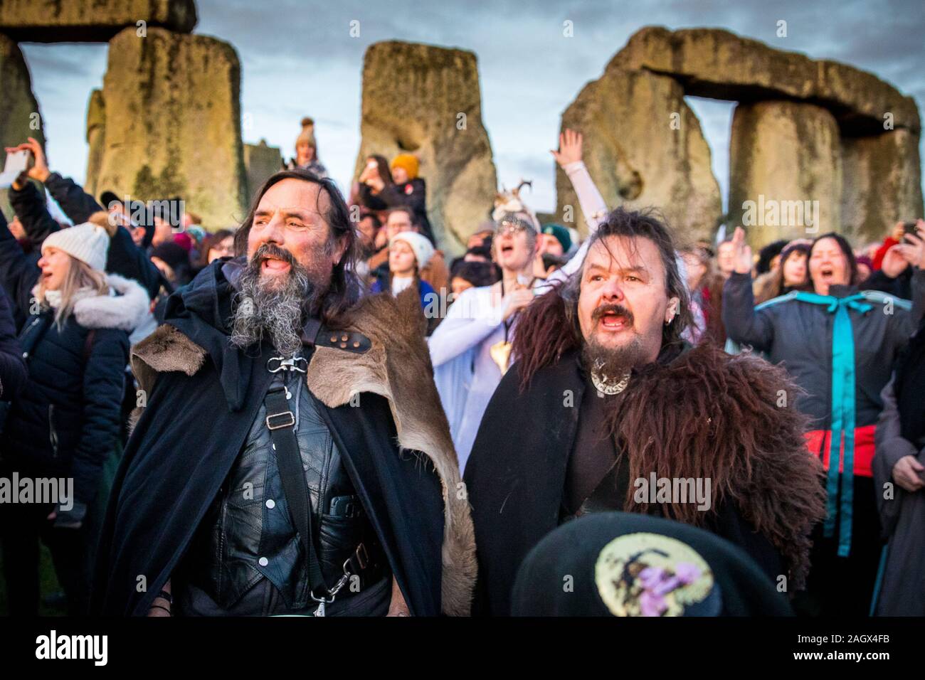 Salisbury, UK. 22nd Dec, 2019. Druids celebrate at sunrise on the shortest day December 22nd 2019. Hundreds of people gathered the famous historic stone circle, in Wiltshire, to celebrate the sunrise on the Winter Solstice the shortest day of the year The event is claimed to be more important in the pagan calendar than the summer solstice because it marks the rebirth of the Sun for the year ahead Credit: David Betteridge/Alamy Live News Stock Photo